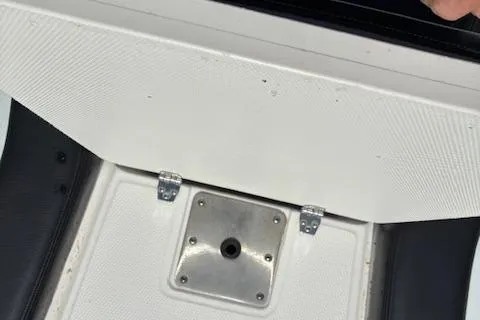 Slide: The Image of 2018 Chaparral 191 Suncoast boat seat compartment with metal hinges and mounting plate. - 20