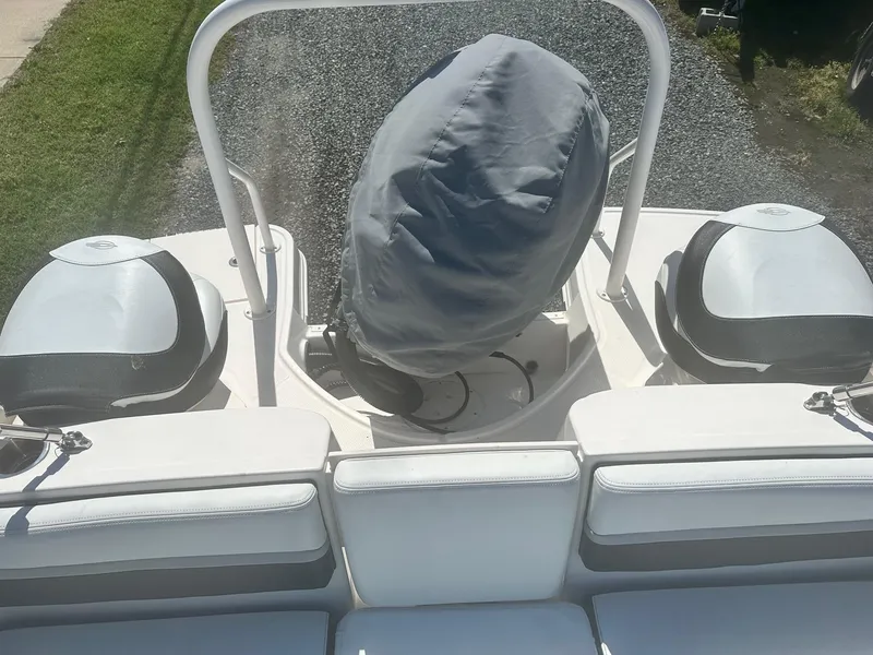 Slide: The Image of 2018 Chaparral 191 Suncoast boat interior with covered engine and seating area. - 22