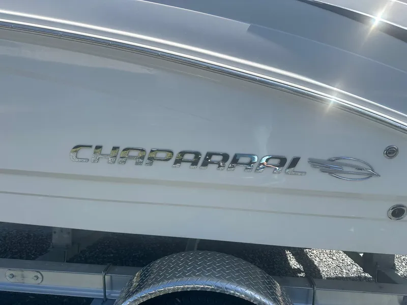 Slide: The Image of 2018 Chaparral 191 Suncoast boat side view with logo and trailer. - 6