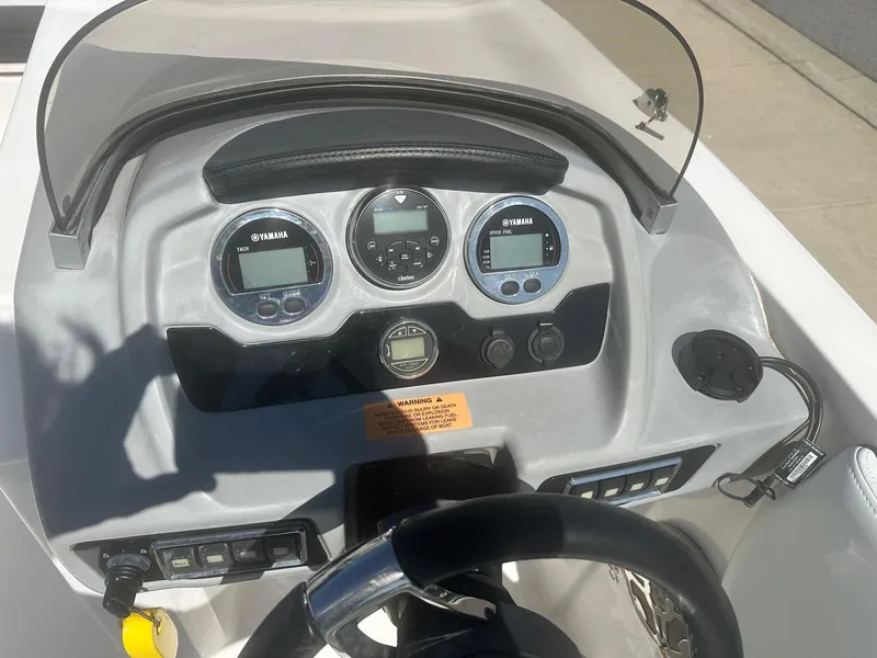 Slide: The Image of 2018 Chaparral 191 Suncoast boat dashboard with Yamaha gauges and steering wheel. - 7