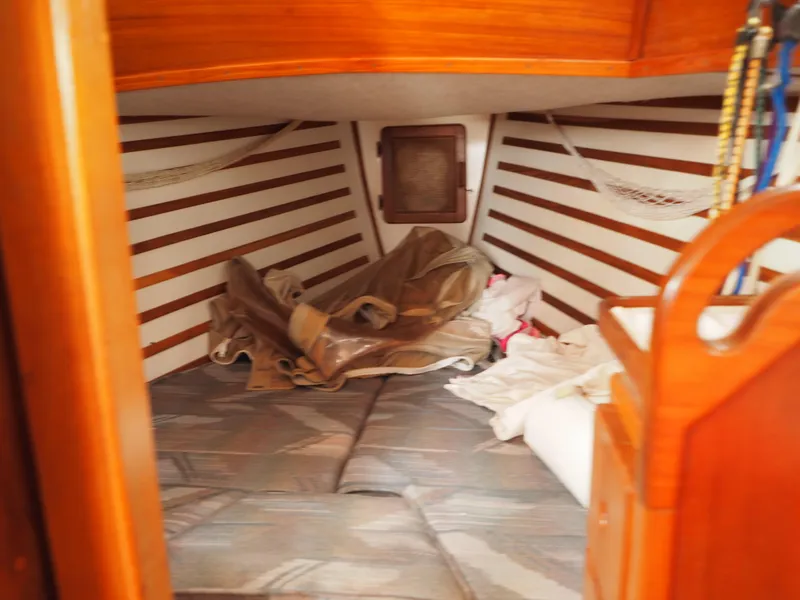 Slide: The Image of Cozy cabin interior of 1996 Com-Pac 27-2 sailboat with wooden accents and storage nets. - 11