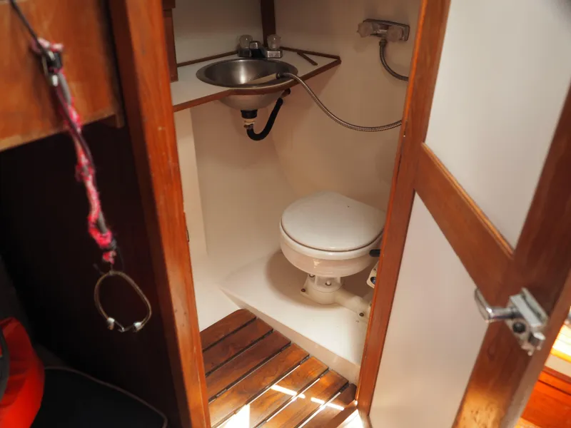 Slide: The Image of Compact marine bathroom in 1996 Com-Pac 27-2 sailboat with toilet and sink. - 13
