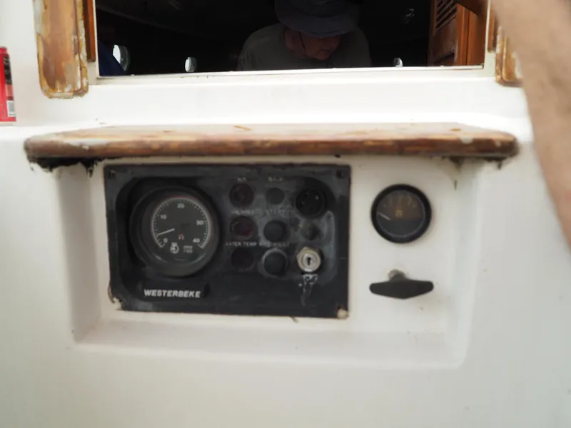 Slide: The Image of Control panel of a 1996 Com-Pac 27-2 sailboat with gauges and switches. - 23