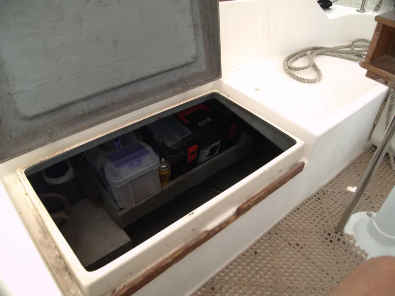 Slide: The Image of Storage compartment on a 1996 Com-Pac 27-2 sailboat, containing tools and supplies. - 24