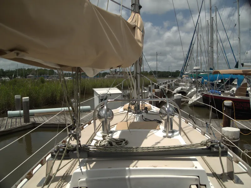 Slide: The Image of Sailboat Com-Pac 27-2, 1996 model, docked at marina under cloudy sky. - 7