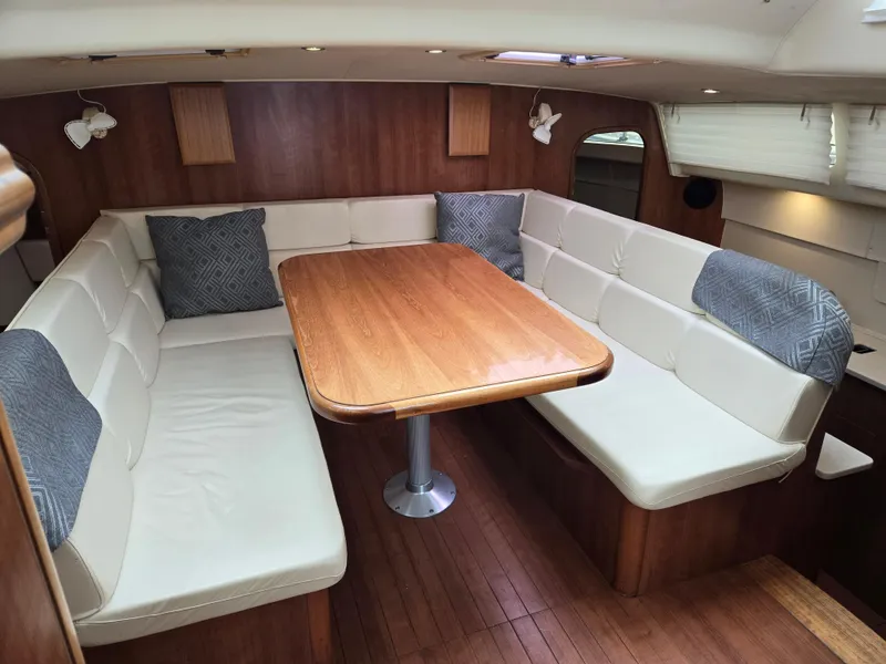 Slide: The Image of Interior of 2013 Gemini Legacy 35 yacht with cozy dining area and wooden table. - 16
