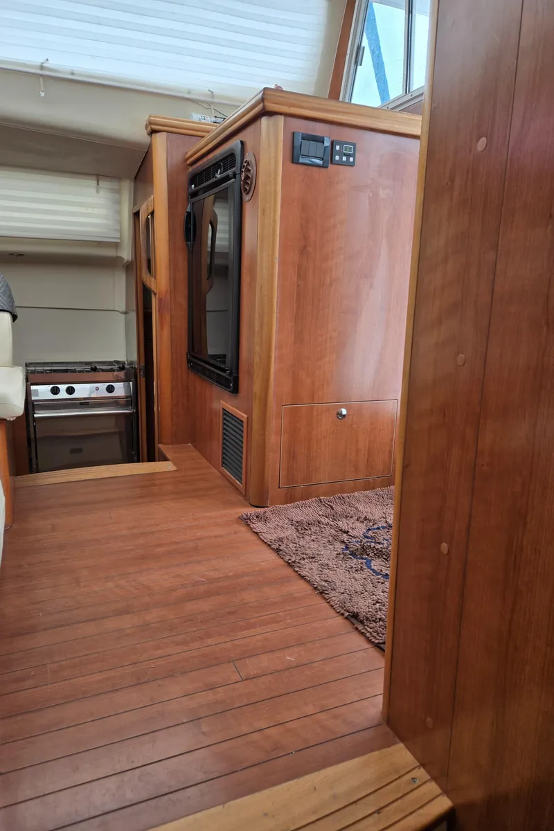 Slide: The Image of Interior of 2013 Gemini Legacy 35 yacht with wood paneling and compact kitchen area. - 25