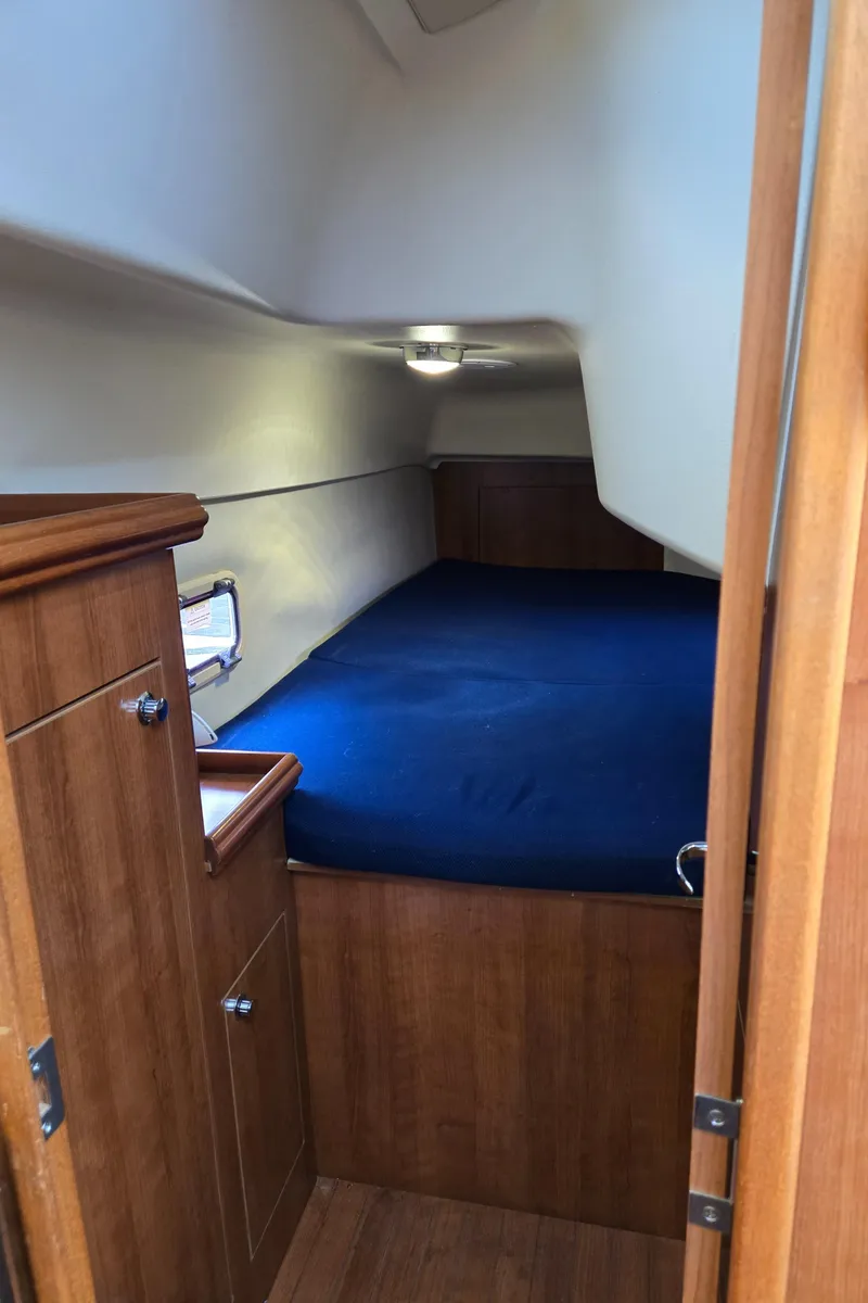 Slide: The Image of Cozy cabin interior of 2013 Gemini Legacy 35 sailboat with blue bedding. - 27
