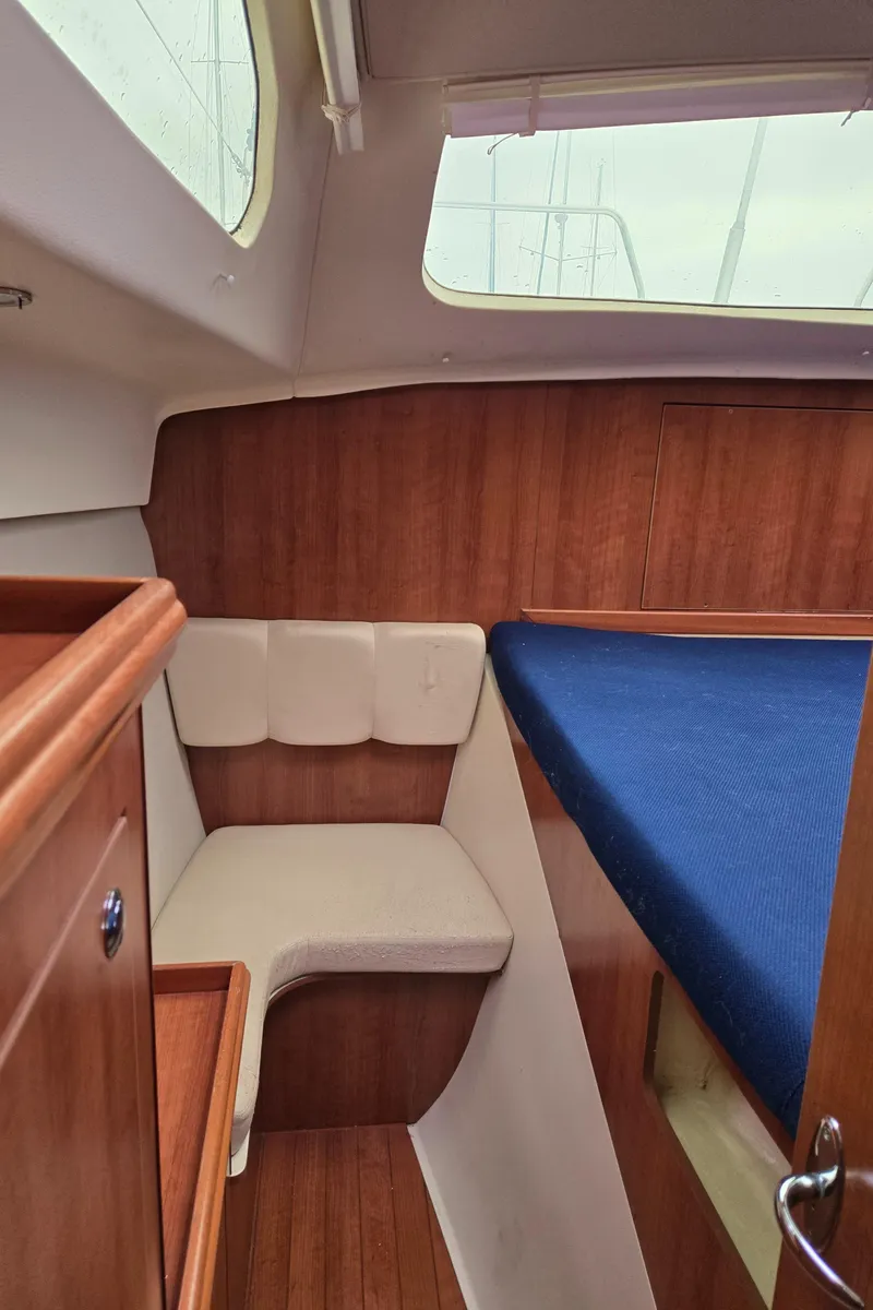 Slide: The Image of Interior of 2013 Gemini Legacy 35 sailboat with wood paneling and blue bedding. - 28