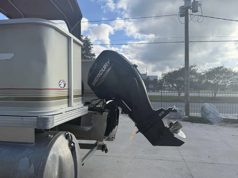 Slide: The Image of 2003 Crest 18 Fisherman boat with Mercury outboard motor, parked outdoors. - 9