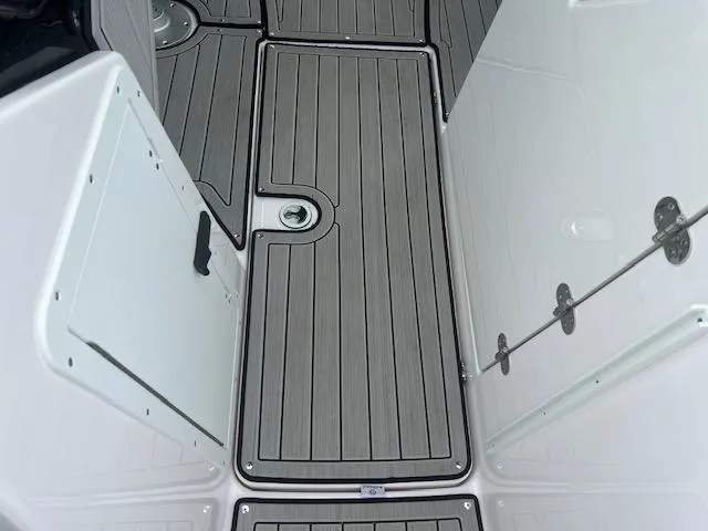 Slide: The Image of 2024 Yamaha Boats 252 S deck with sleek, modern design and durable flooring. - 12