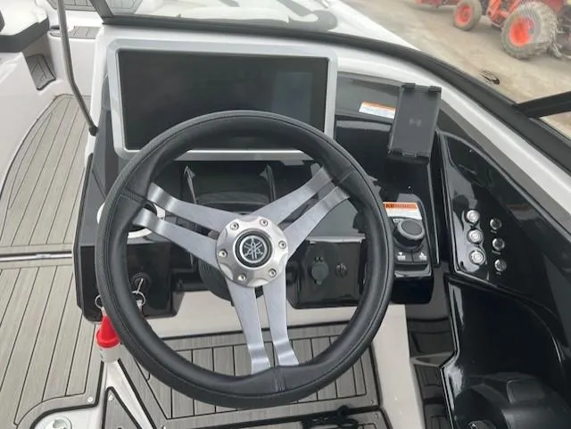 Slide: The Image of 2024 Yamaha Boats 252 S steering wheel and dashboard controls. - 15