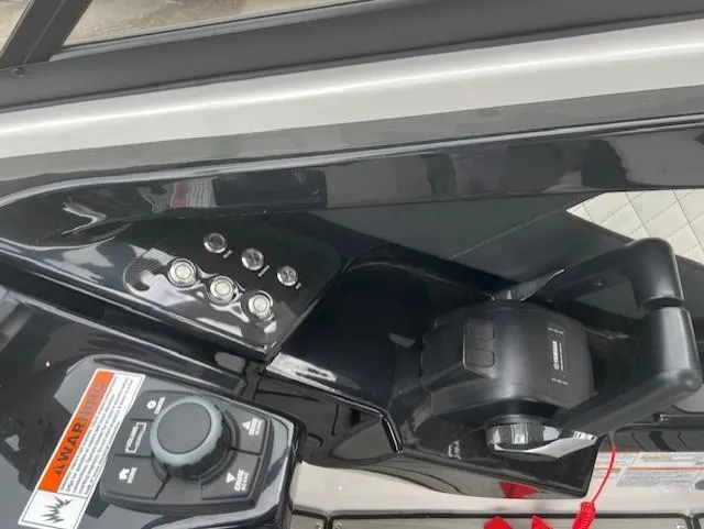 Slide: The Image of 2024 Yamaha Boats 252 S control panel with throttle and switches. - 16