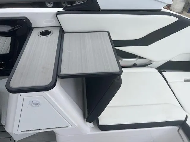 Slide: The Image of 2024 Yamaha Boats 252 S interior with sleek seating and foldable table. - 17