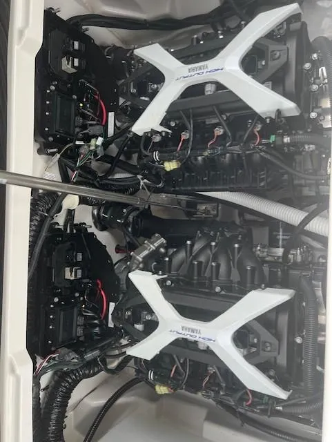 Slide: The Image of 2024 Yamaha Boats 252 S engine compartment showcasing dual engines and wiring. - 21