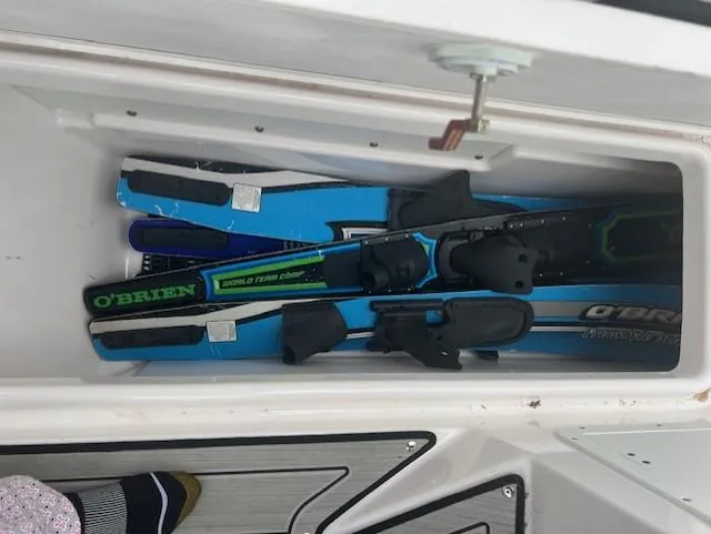 Slide: The Image of Storage compartment with water skis on a 2024 Yamaha Boats 252 S. - 24