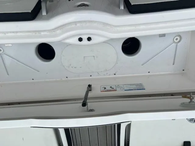 Slide: The Image of 2024 Yamaha Boats 252 S swim platform with storage compartment and seating area. - 27