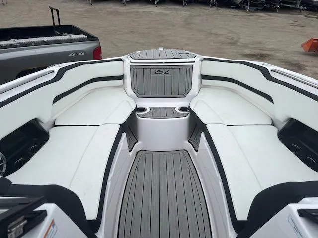 Slide: The Image of 2024 Yamaha Boats 252 S interior with white seating and gray flooring. - 5