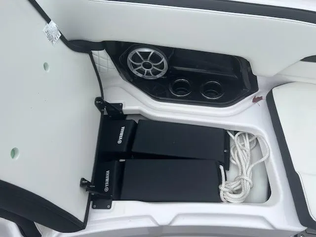 Slide: The Image of 2024 Yamaha Boats 252 S interior storage with speaker and cup holders. - 9