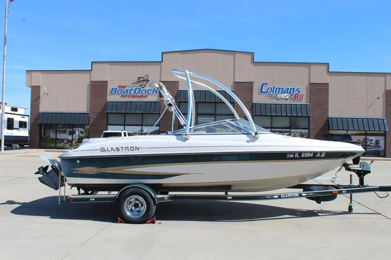 Slide: The Image of 2001 Glastron GX 185 boat on trailer outside dealership. - 0