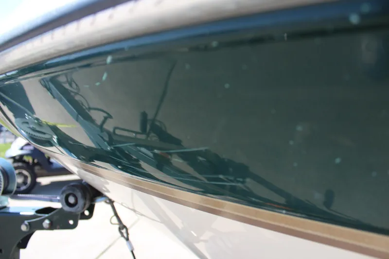 Slide: The Image of 2001 Glastron GX 185 boat hull close-up, showing sleek green finish. - 10