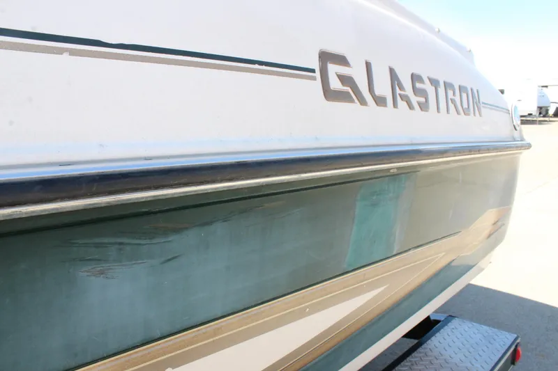 Slide: The Image of 2001 Glastron GX 185 boat side view with visible logo and trailer. - 11