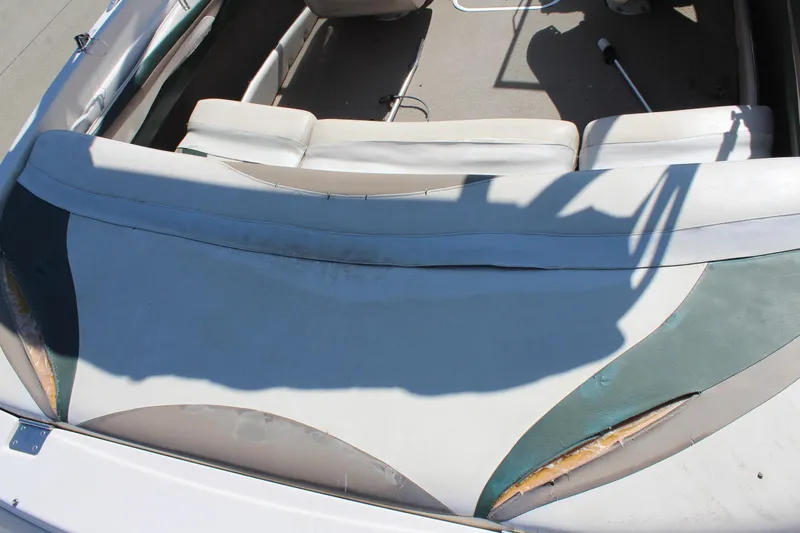 Slide: The Image of 2001 Glastron GX 185 boat interior with worn upholstery and visible seat damage. - 14