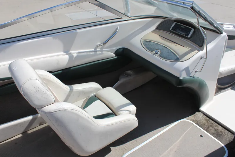 Slide: The Image of 2001 Glastron GX 185 boat interior with white seating and dashboard. - 17
