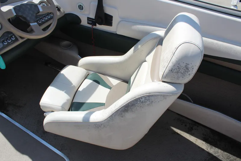 Slide: The Image of 2001 Glastron GX 185 boat interior with white captain's seat and dashboard. - 19