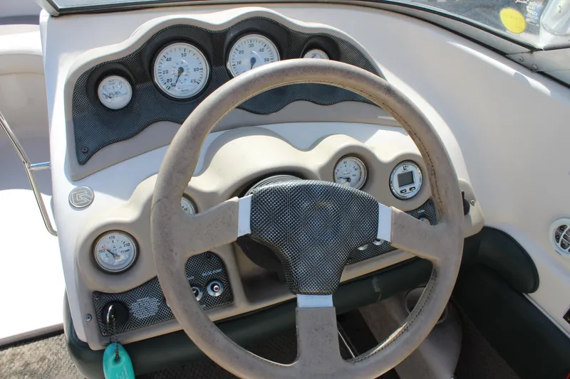 Slide: The Image of 2001 Glastron GX 185 boat dashboard with steering wheel and gauges. - 20