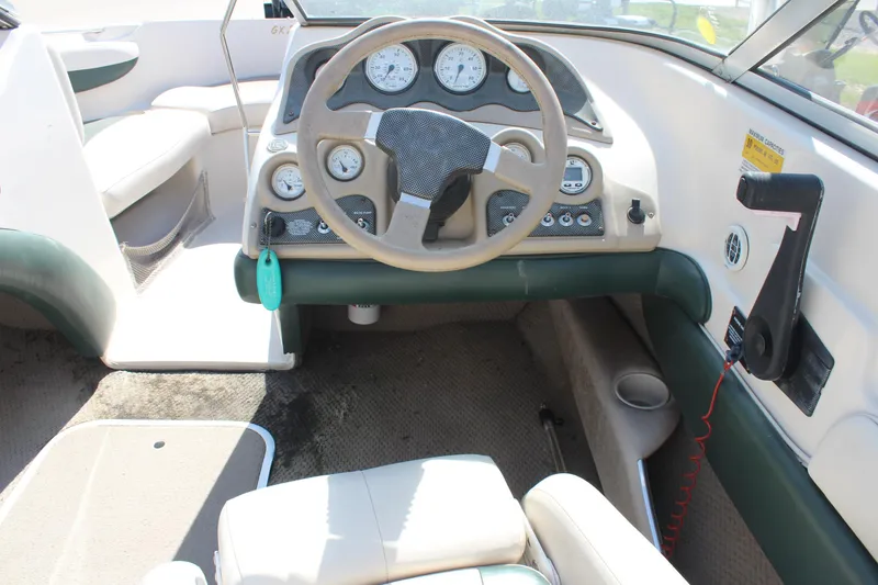 Slide: The Image of 2001 Glastron GX 185 boat interior with steering wheel and dashboard controls. - 21