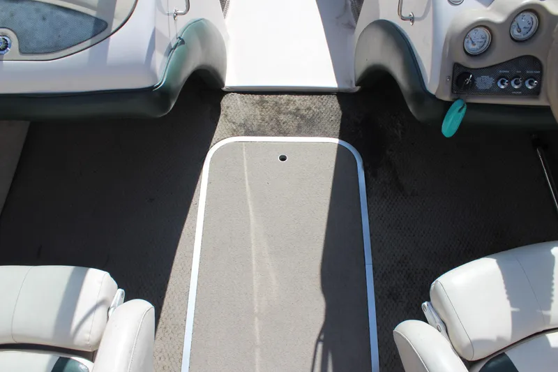 Slide: The Image of Interior of 2001 Glastron GX 185 boat showing seating and dashboard controls. - 24