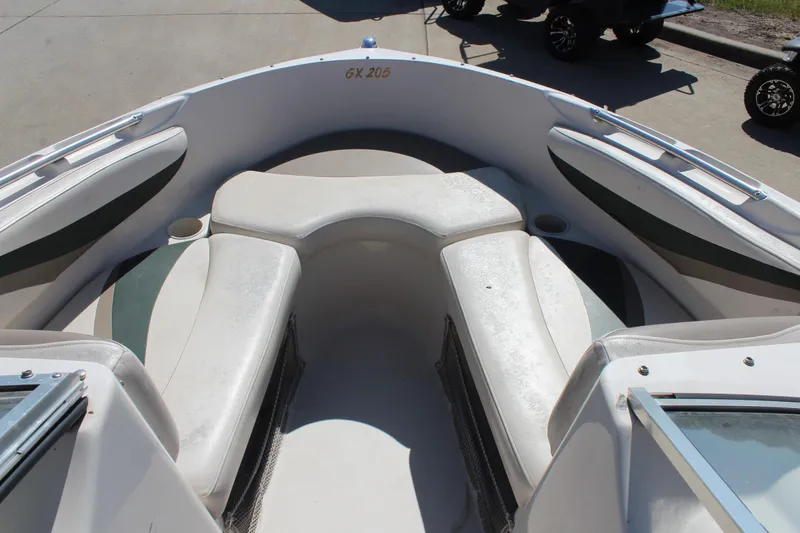 Slide: The Image of 2001 Glastron GX 185 boat interior with white seating and cup holders. - 26
