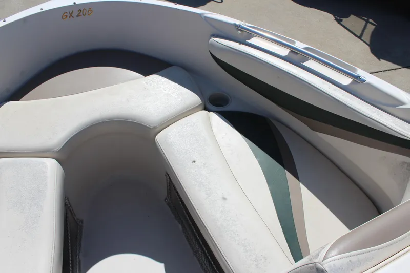 Slide: The Image of 2001 Glastron GX 185 boat interior with cushioned seating and storage compartments. - 28