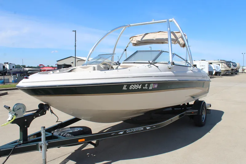 Slide: The Image of 2001 Glastron GX 185 boat on trailer, parked outdoors under clear blue sky. - 3
