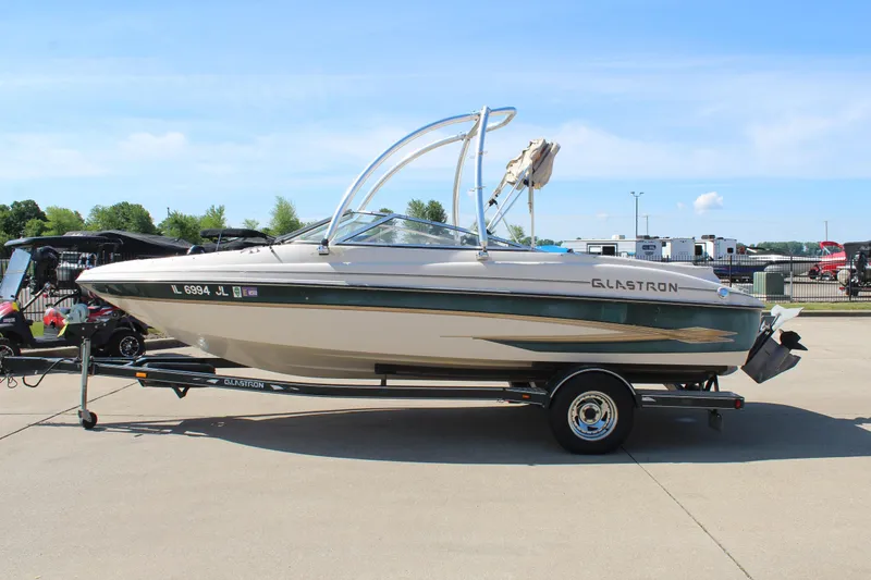 Slide: The Image of 2001 Glastron GX 185 boat on trailer, parked outdoors on a sunny day. - 4