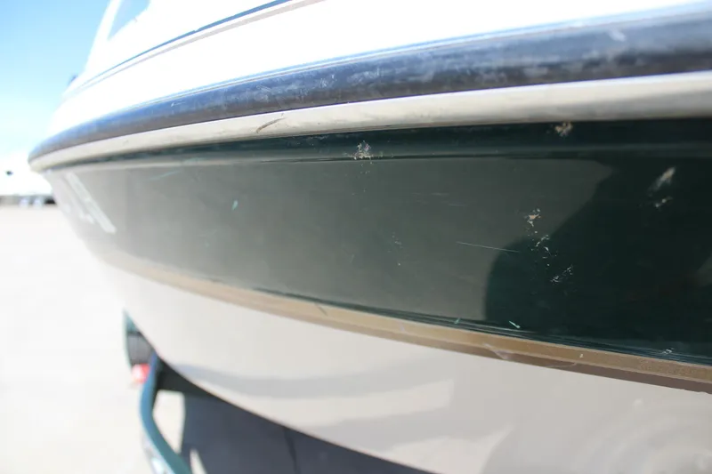 Slide: The Image of 2001 Glastron GX 185 boat hull with visible scratches and wear. - 9