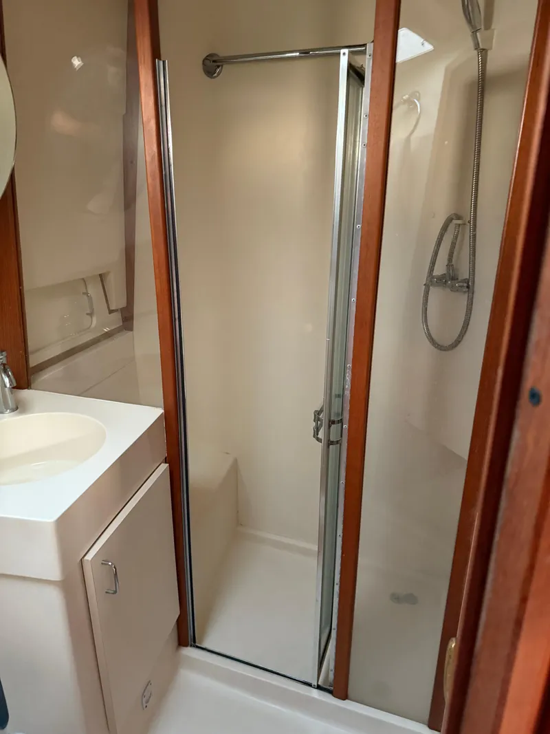 Slide: The Image of Bathroom interior of 2000 Mainship 390 Trawler with shower and sink. - 16