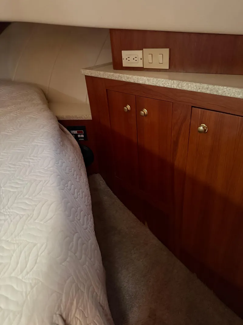 Slide: The Image of 2000 Mainship 390 Trawler cabin with wooden cabinets and bed. - 17