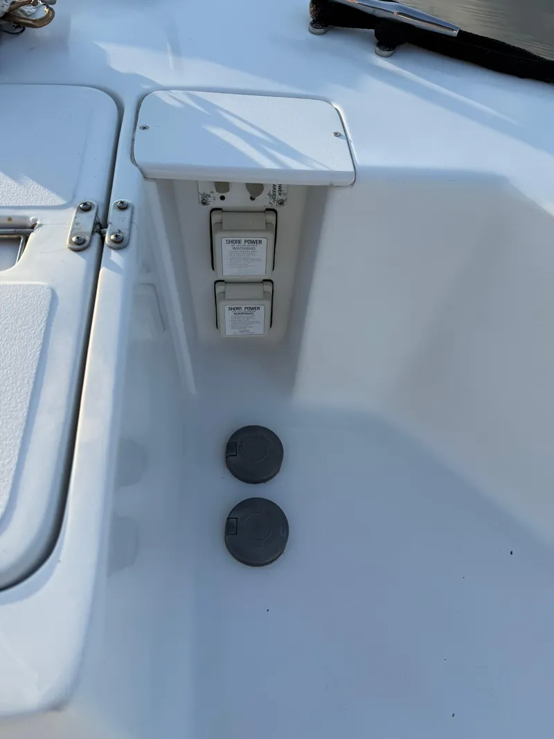 Slide: The Image of 2000 Mainship 390 Trawler deck with electrical outlets and storage compartment. - 22