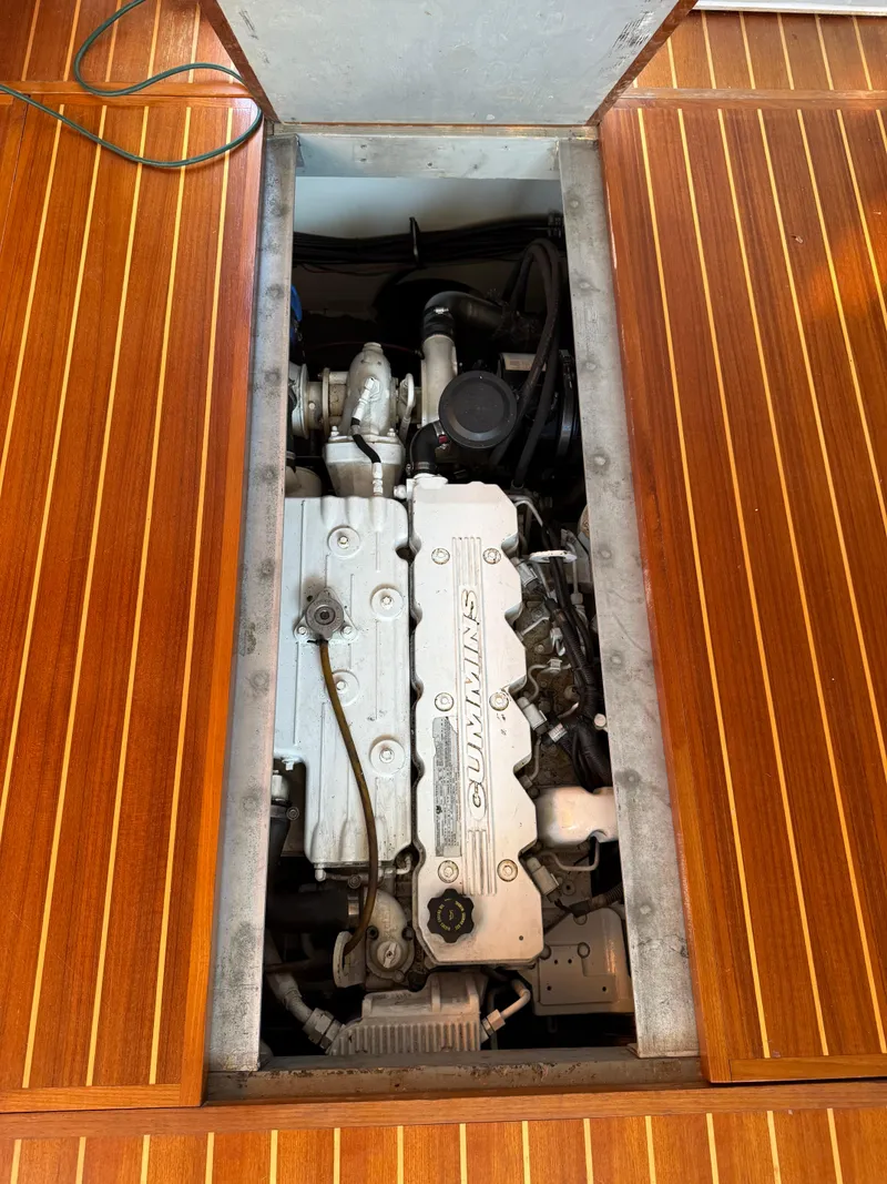 Slide: The Image of Engine compartment of a 2000 Mainship 390 Trawler, showcasing a well-maintained marine engine. - 25