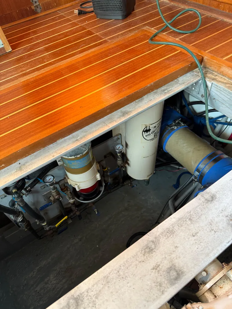 Slide: The Image of Engine compartment of 2000 Mainship 390 Trawler with visible filters and equipment. - 26