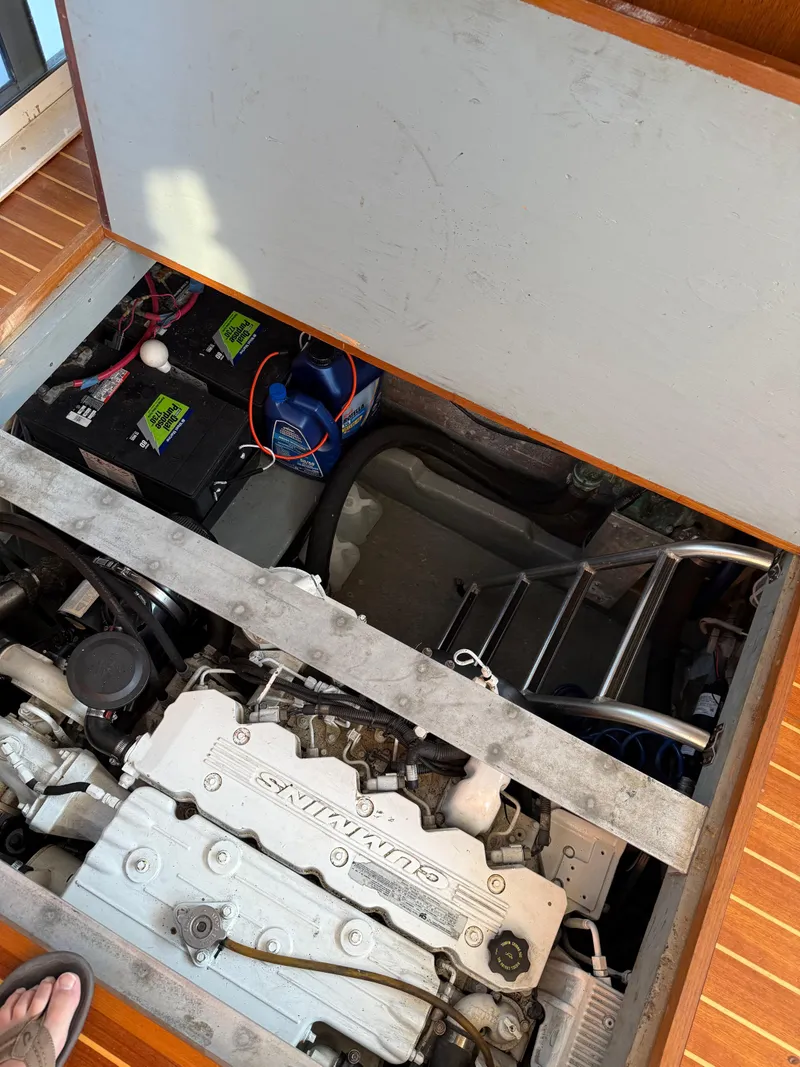 Slide: The Image of Engine compartment of a 2000 Mainship 390 Trawler with visible components and batteries. - 27