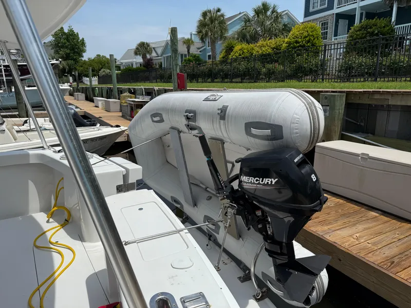 Slide: The Image of 2000 Mainship 390 Trawler with inflatable boat and Mercury outboard motor docked at marina. - 4