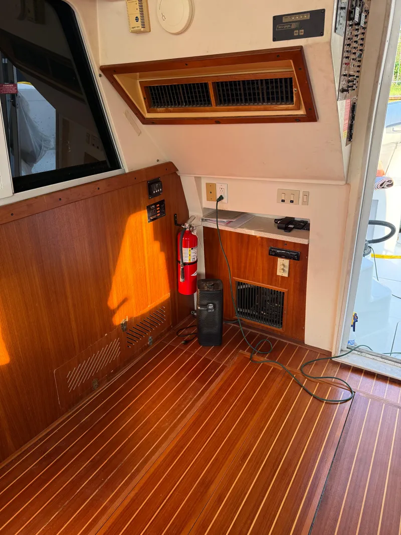 Slide: The Image of Interior of a 2000 Mainship 390 Trawler with wood paneling and safety equipment. - 6