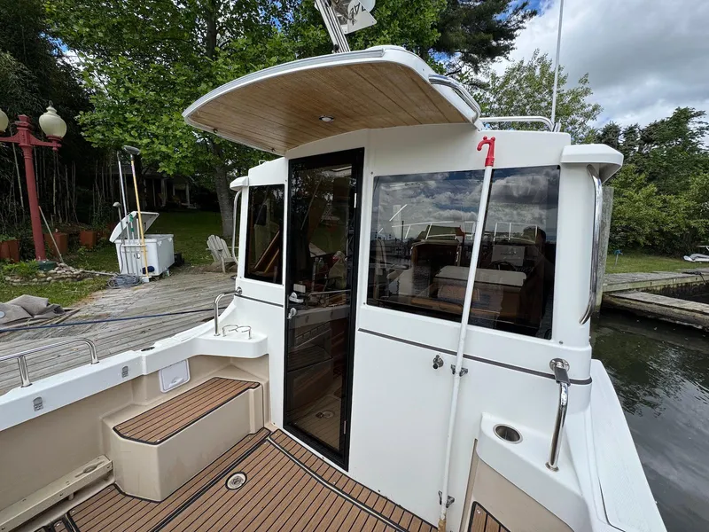 Slide: The Image of 2016 Cutwater C-26 boat docked, featuring a spacious deck and modern cabin design. - 10