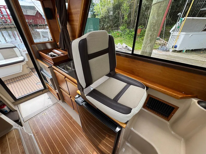 Slide: The Image of Interior of a 2016 Cutwater C-26 boat with seating and wooden flooring. - 17