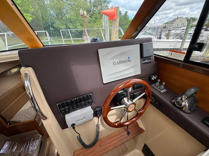 Slide: The Image of 2016 Cutwater C-26 boat helm with Garmin navigation system and wooden steering wheel. - 18