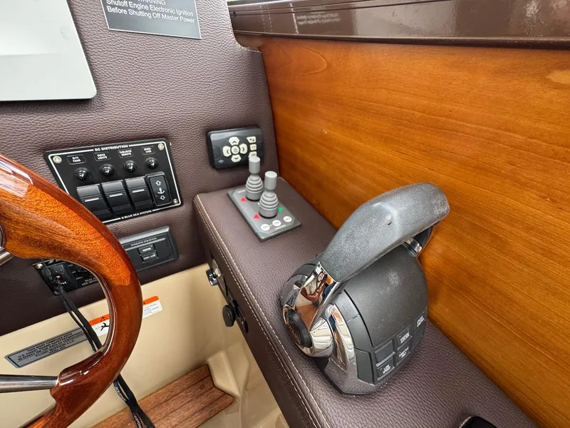 Slide: The Image of Control panel of a 2016 Cutwater C-26 boat with throttle and joystick. - 19