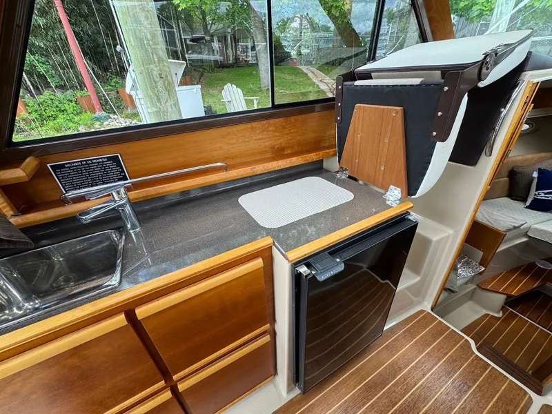 Slide: The Image of 2016 Cutwater C-26 boat interior with kitchenette, sink, and compact fridge. - 25